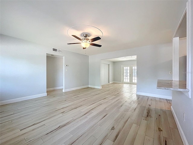 2631 Mcdonald Ter, Mount Dora, FL 32757 - unfurnished living room featuring ceiling fan, french doors, visible vents, baseboards, and light wood-style flooring