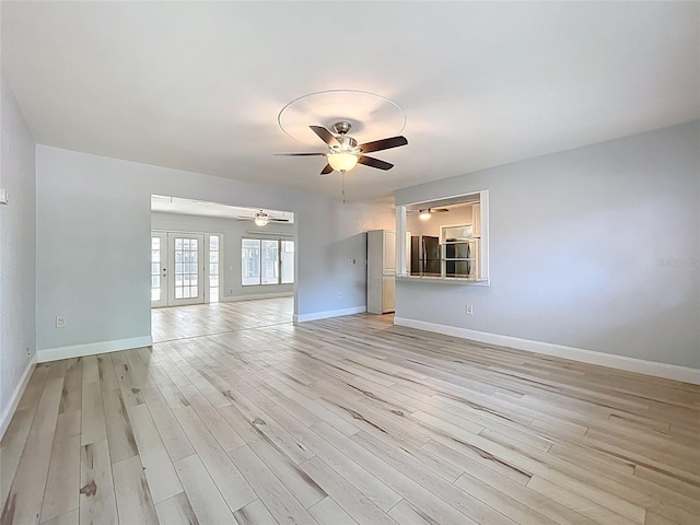 2631 Mcdonald Ter, Mount Dora, FL 32757 - unfurnished living room featuring a ceiling fan, baseboards, and light wood-style flooring
