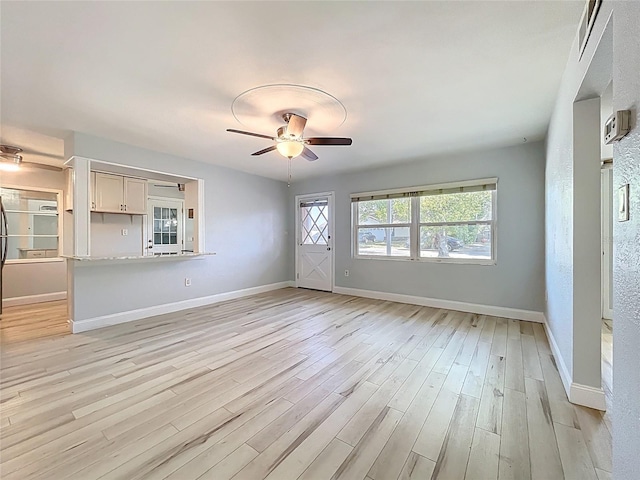 2631 Mcdonald Ter, Mount Dora, FL 32757 - unfurnished living room with a ceiling fan, baseboards, and light wood-style floors