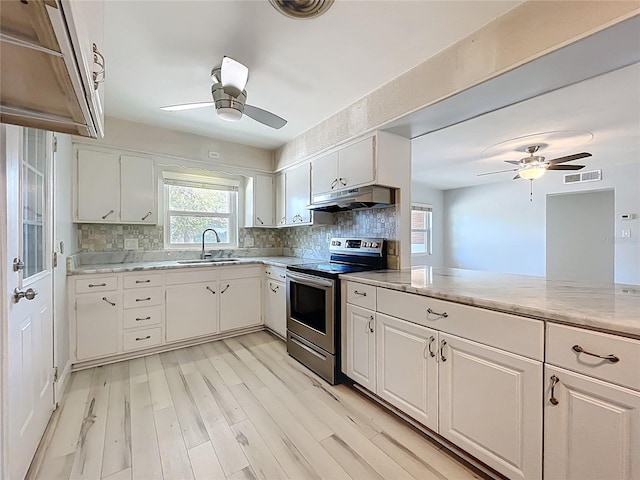 2631 Mcdonald Ter, Mount Dora, FL 32757 - kitchen featuring electric range, ceiling fan, a sink, light wood-style floors, and under cabinet range hood