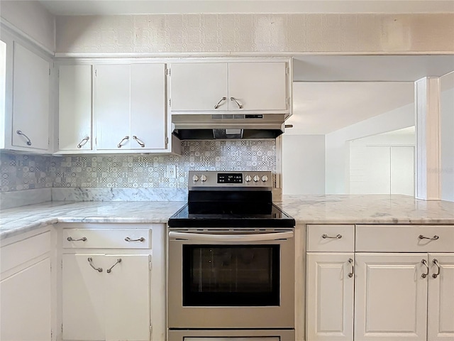 2631 Mcdonald Ter, Mount Dora, FL 32757 - kitchen with backsplash, light stone countertops, white cabinets, electric stove, and under cabinet range hood