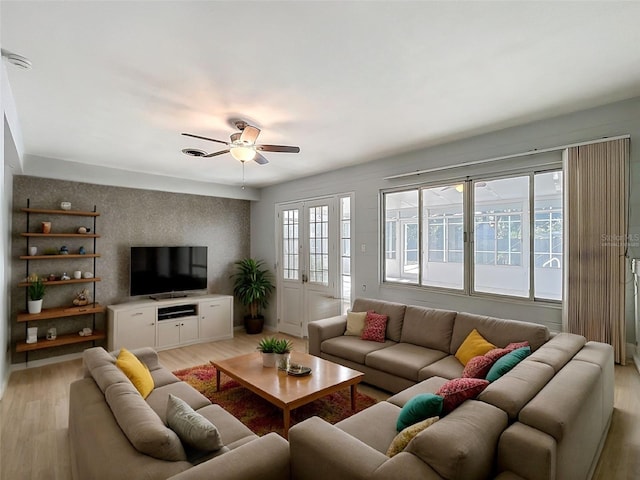 2631 Mcdonald Ter, Mount Dora, FL 32757 - living area featuring light wood-type flooring, a ceiling fan, and an accent wall