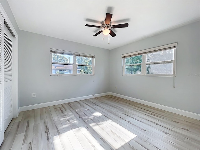 2631 Mcdonald Ter, Mount Dora, FL 32757 - unfurnished bedroom featuring baseboards, a ceiling fan, a closet, and light wood-type flooring