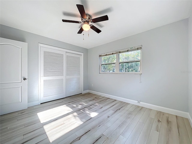 2631 Mcdonald Ter, Mount Dora, FL 32757 - unfurnished bedroom with baseboards, light wood-style flooring, ceiling fan, and a closet