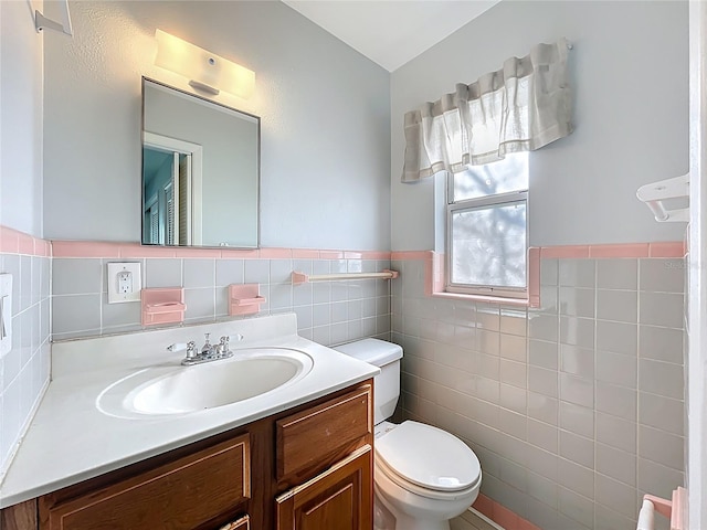 2631 Mcdonald Ter, Mount Dora, FL 32757 - half bath featuring tile walls, a wainscoted wall, vanity, and toilet