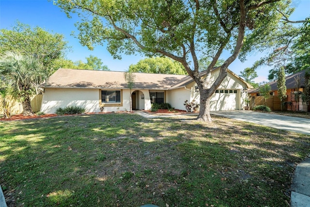 ranch-style house featuring stucco siding, driveway, a front lawn, and a garage