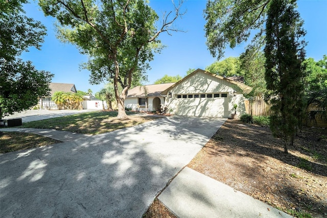 single story home with fence, an attached garage, and concrete driveway