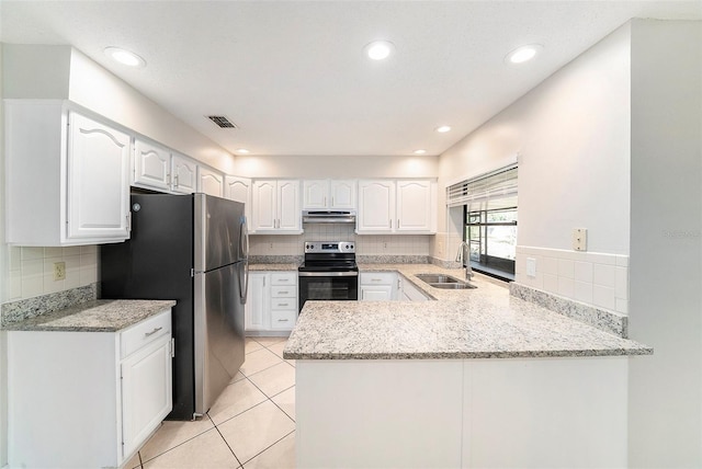 kitchen with appliances with stainless steel finishes, tasteful backsplash, a sink, a peninsula, and under cabinet range hood