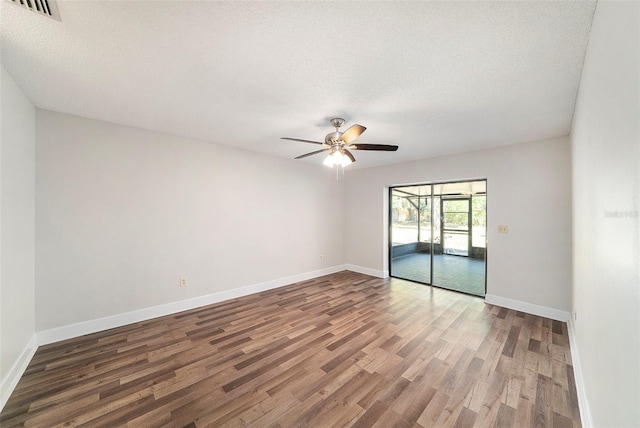 spare room featuring baseboards, ceiling fan, and wood finished floors