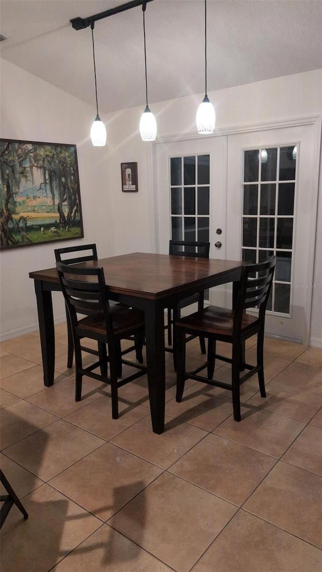 dining space featuring baseboards, light tile patterned flooring, and visible vents