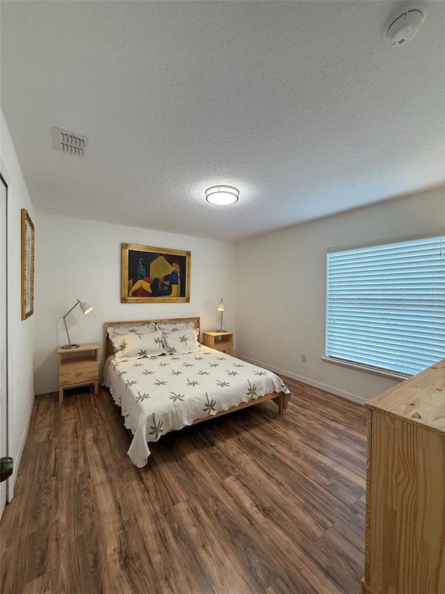 4920 E Lake Cove Blvd, Saint Cloud, FL 34771 - bedroom with wood finished floors, baseboards, and a textured ceiling