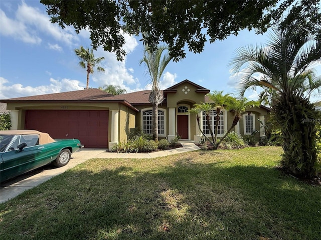 4920 E Lake Cove Blvd, Saint Cloud, FL 34771 - view of front of house with stucco siding, a garage, a front yard, and concrete driveway