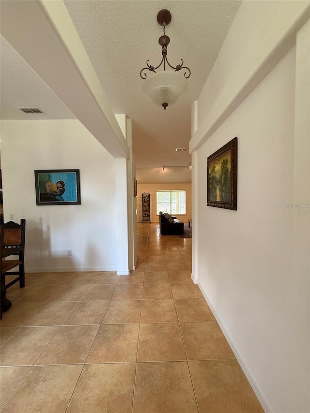 4920 E Lake Cove Blvd, Saint Cloud, FL 34771 - hall featuring light tile patterned floors, baseboards, and rail lighting