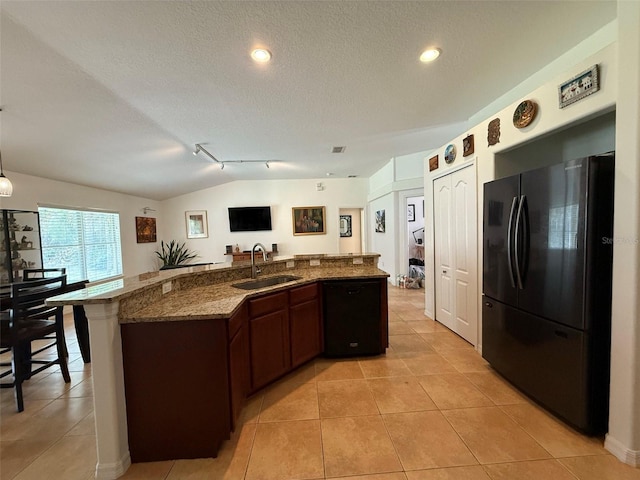 4920 E Lake Cove Blvd, Saint Cloud, FL 34771 - kitchen with freestanding refrigerator, a sink, stone counters, a textured ceiling, and light tile patterned flooring