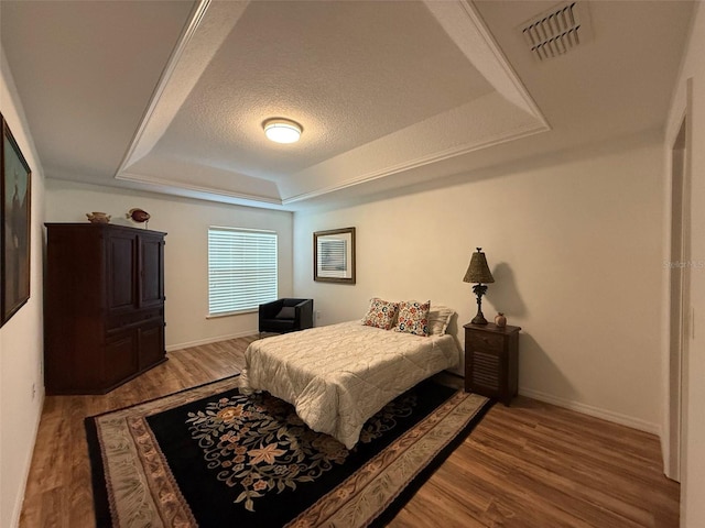 4920 E Lake Cove Blvd, Saint Cloud, FL 34771 - bedroom with a raised ceiling, wood finished floors, baseboards, and a textured ceiling