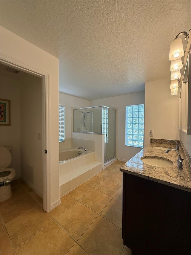 4920 E Lake Cove Blvd, Saint Cloud, FL 34771 - full bathroom with a bath, tile patterned flooring, double vanity, toilet, and a stall shower