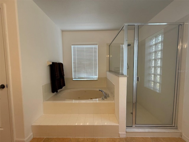 4920 E Lake Cove Blvd, Saint Cloud, FL 34771 - full bathroom with a whirlpool tub, a stall shower, and tile patterned flooring