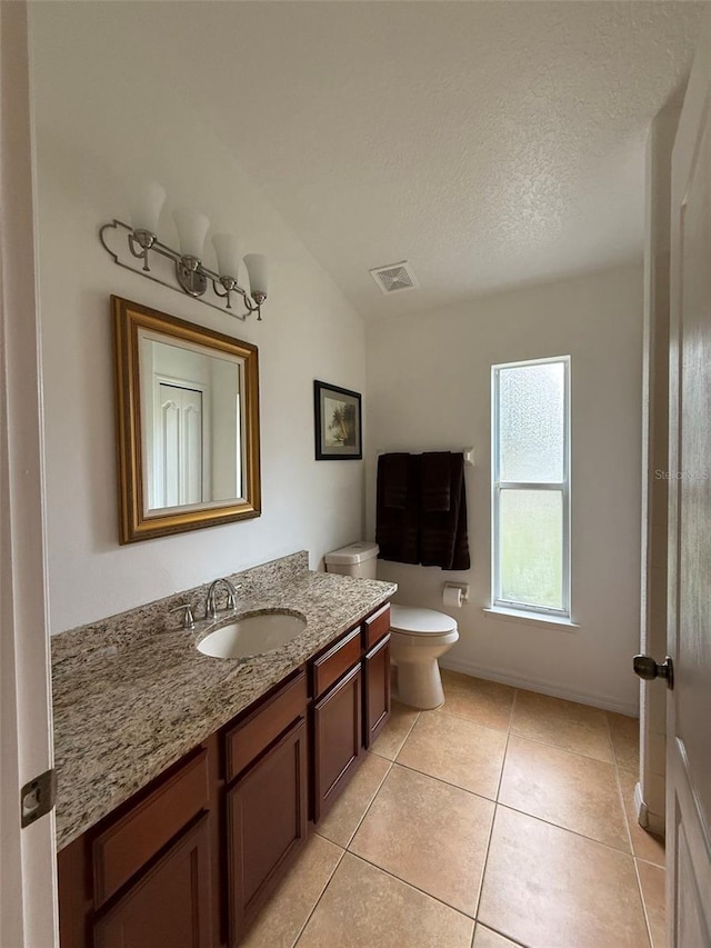 4920 E Lake Cove Blvd, Saint Cloud, FL 34771 - bathroom featuring vanity, toilet, tile patterned floors, and a textured ceiling