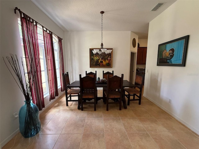 4920 E Lake Cove Blvd, Saint Cloud, FL 34771 - dining space with a chandelier, plenty of natural light, light tile patterned floors, and a textured ceiling