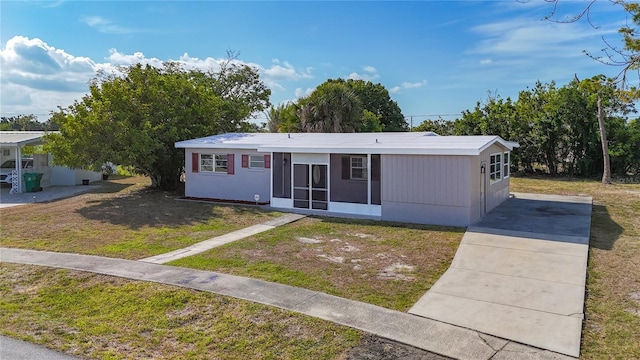 22131 Bahama Ave, Port Charlotte, FL 33952 - manufactured / mobile home with concrete driveway, a sunroom, and a front yard
