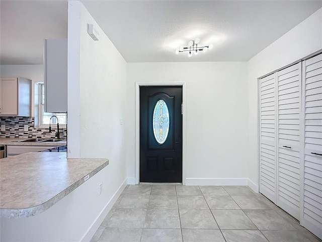 22131 Bahama Ave, Port Charlotte, FL 33952 - foyer entrance featuring baseboards and light tile patterned floors