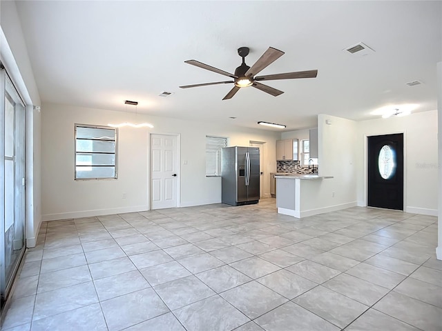 22131 Bahama Ave, Port Charlotte, FL 33952 - unfurnished living room featuring a ceiling fan, visible vents, and light tile patterned floors