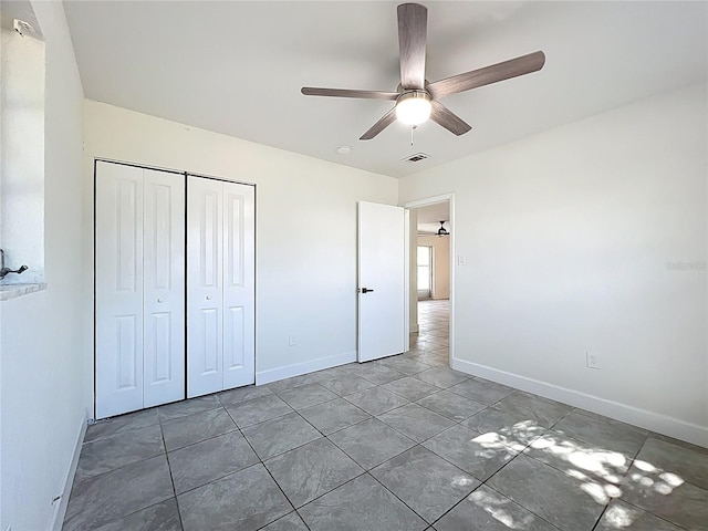 22131 Bahama Ave, Port Charlotte, FL 33952 - unfurnished bedroom with ceiling fan, visible vents, tile patterned flooring, baseboards, and a closet
