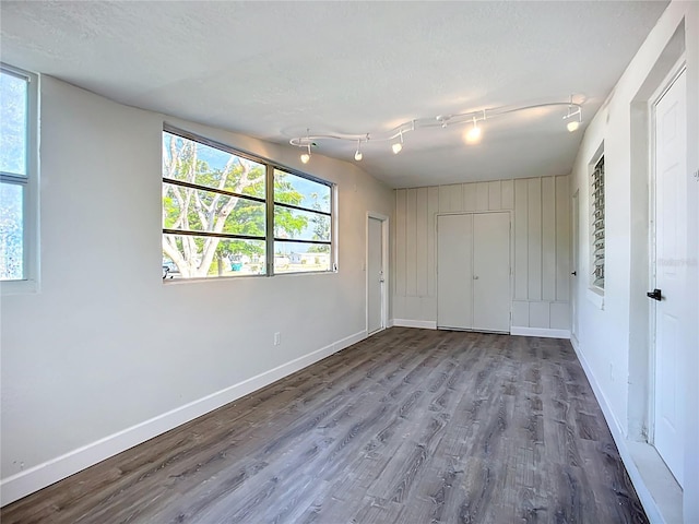 22131 Bahama Ave, Port Charlotte, FL 33952 - unfurnished bedroom with baseboards, multiple windows, and wood finished floors