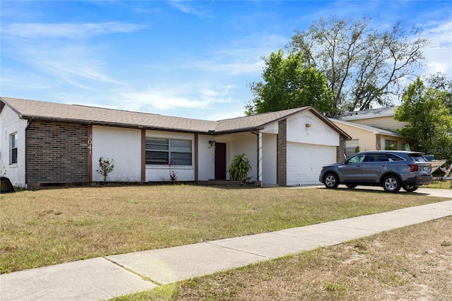 single story home with brick siding, an attached garage, roof with shingles, and a front lawn