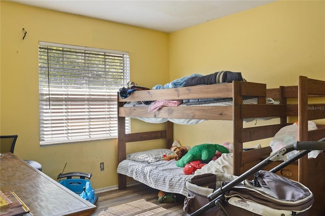bedroom featuring baseboards and wood finished floors