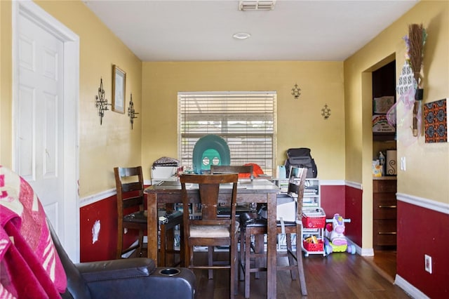 dining room featuring wood finished floors and visible vents