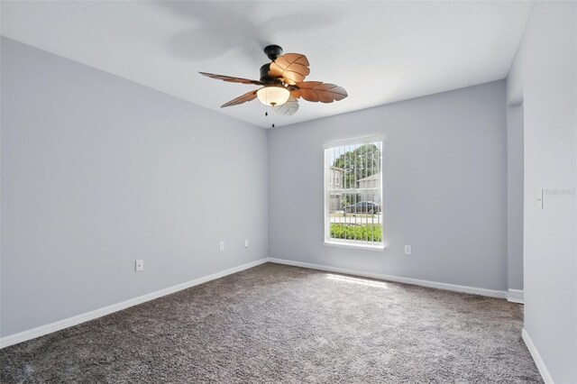 empty room with baseboards, ceiling fan, and carpet flooring