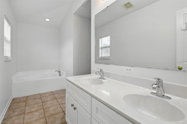 full bath featuring a sink, tile patterned flooring, a bath, and visible vents