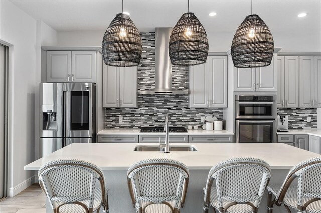 8848 Bismarck Palm Dr, Winter Garden, FL 34787 - kitchen with gray cabinets, tasteful backsplash, light countertops, stainless steel appliances, and wall chimney exhaust hood