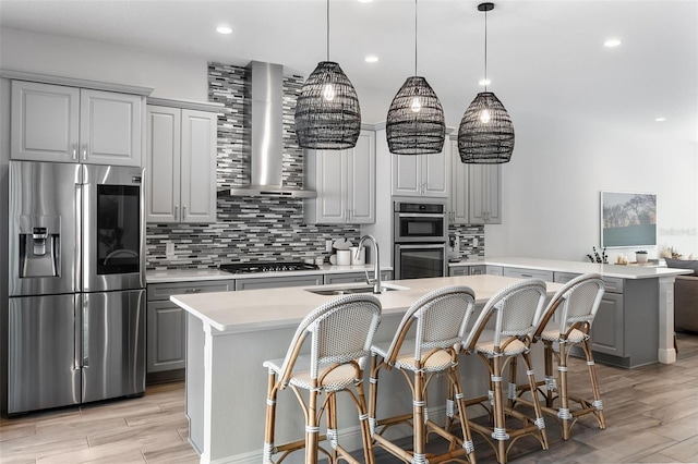 8848 Bismarck Palm Dr, Winter Garden, FL 34787 - kitchen with decorative backsplash, gray cabinetry, a sink, stainless steel appliances, and wall chimney exhaust hood