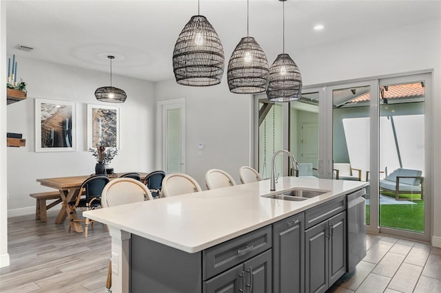 8848 Bismarck Palm Dr, Winter Garden, FL 34787 - kitchen featuring a sink, visible vents, light countertops, baseboards, and gray cabinetry