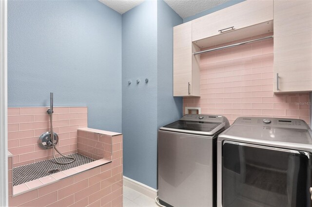 8848 Bismarck Palm Dr, Winter Garden, FL 34787 - washroom featuring laundry area, a textured ceiling, baseboards, light tile patterned floors, and washer and clothes dryer