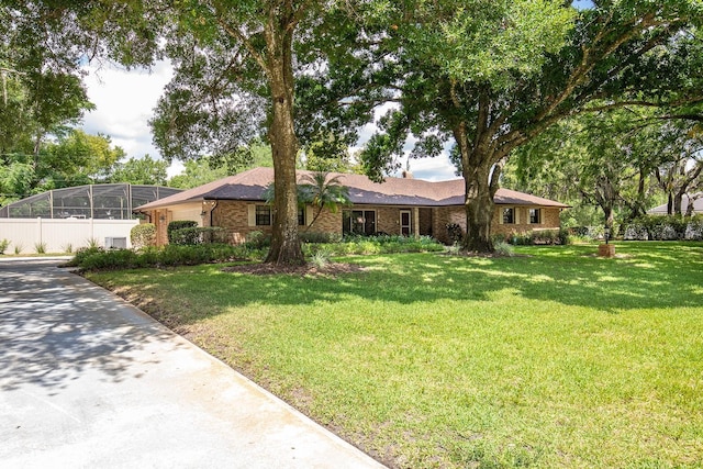 ranch-style house featuring brick siding and a front lawn