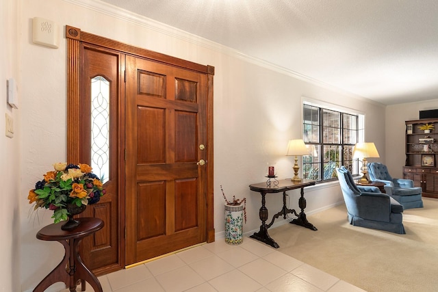 carpeted entryway featuring crown molding and baseboards