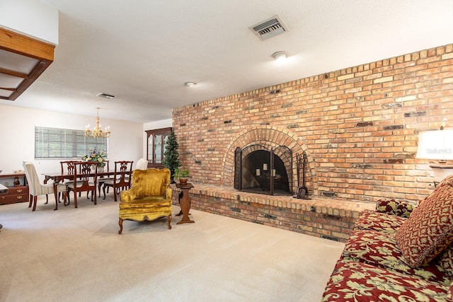 living area featuring a fireplace, an inviting chandelier, visible vents, and carpet floors