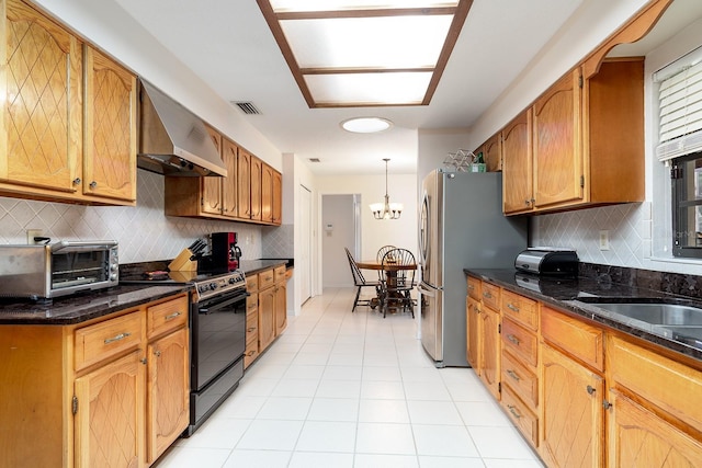 kitchen featuring freestanding refrigerator, a toaster, visible vents, black range with electric stovetop, and wall chimney range hood
