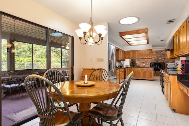 dining space with light tile patterned floors, visible vents, and a notable chandelier