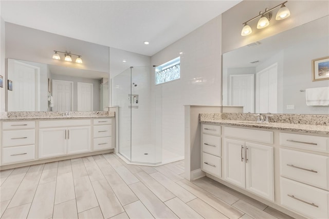 2127 Bay Line Rd, Oakland, FL 34787 - bathroom featuring a shower stall and two vanities