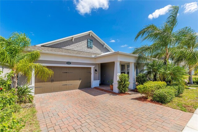 2127 Bay Line Rd, Oakland, FL 34787 - view of front of house with an attached garage, decorative driveway, and stucco siding
