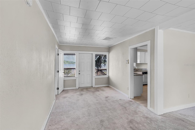 interior space featuring carpet floors, baseboards, and ornamental molding