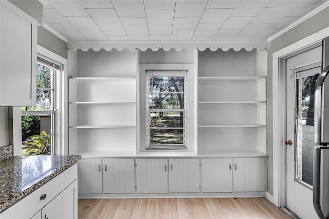 interior space with crown molding and wood finished floors