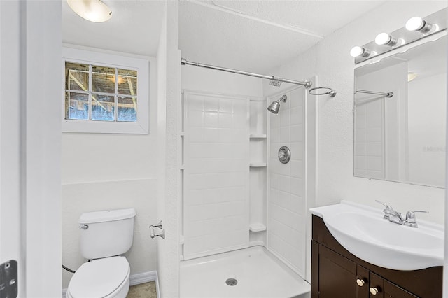 bathroom with vanity, walk in shower, and toilet