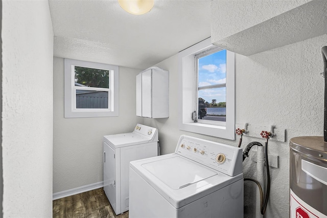 laundry room featuring laundry area, dark wood-style flooring, a textured ceiling, a textured wall, and washer and clothes dryer
