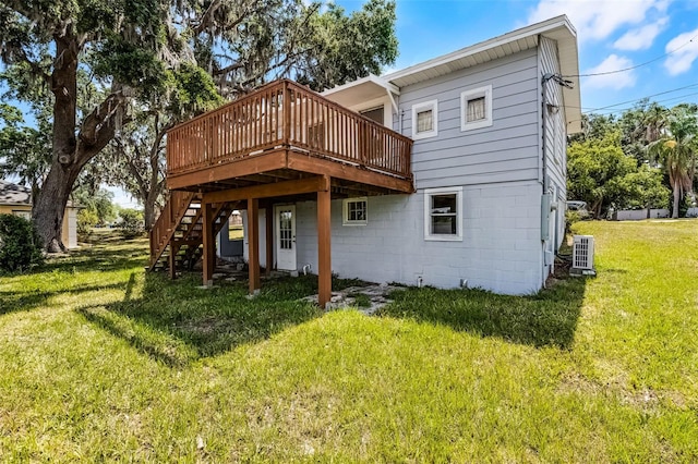 back of house featuring a wooden deck, a yard, and stairway