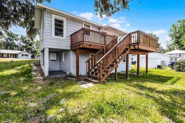 back of property featuring stairs, a yard, and a deck